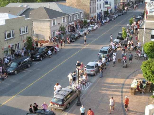 A busy day on Queen Street with many townspeople congregating.